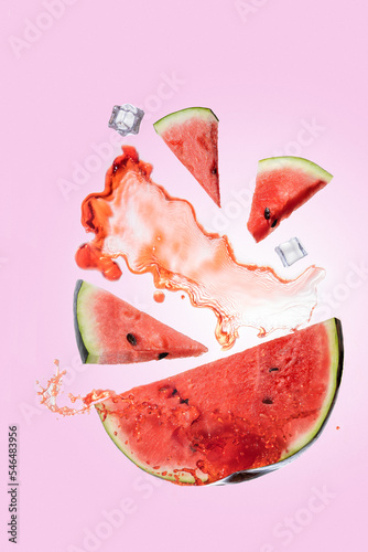 flying watermelon. flying fruits and splashes. splash of watermelon juice. watermelon juice with ice. levitation with fruits and splashes. sliced ​​juicy watermelon