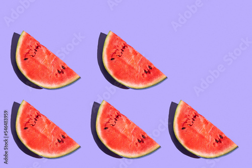 pattern from watermelon on a purple background. fruits on a purple table. juicy ripe watermelon on the dining table. fruit pattern