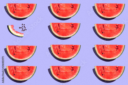 pattern from watermelon on a purple background. fruits on a purple table. juicy ripe watermelon on the dining table. fruit pattern