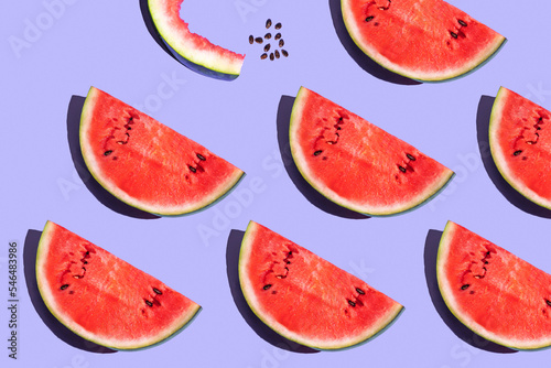 pattern from watermelon on a purple background. fruits on a purple table. juicy ripe watermelon on the dining table. fruit pattern