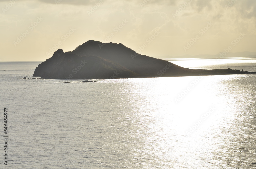 Caribic sun mirroring Water from above Mountains horizon