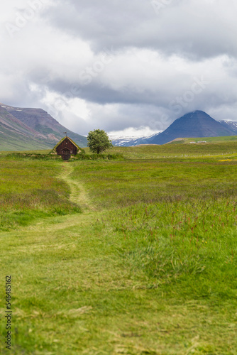 look through a valley with the oldest church of iceland. the Grafarkirkja church photo