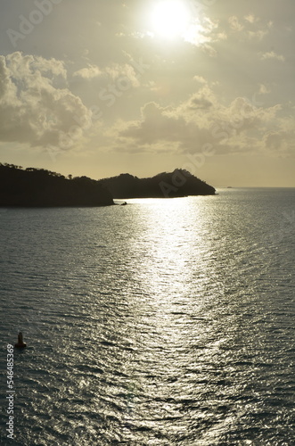 Caribic sun mirroring Water from above Mountains horizon