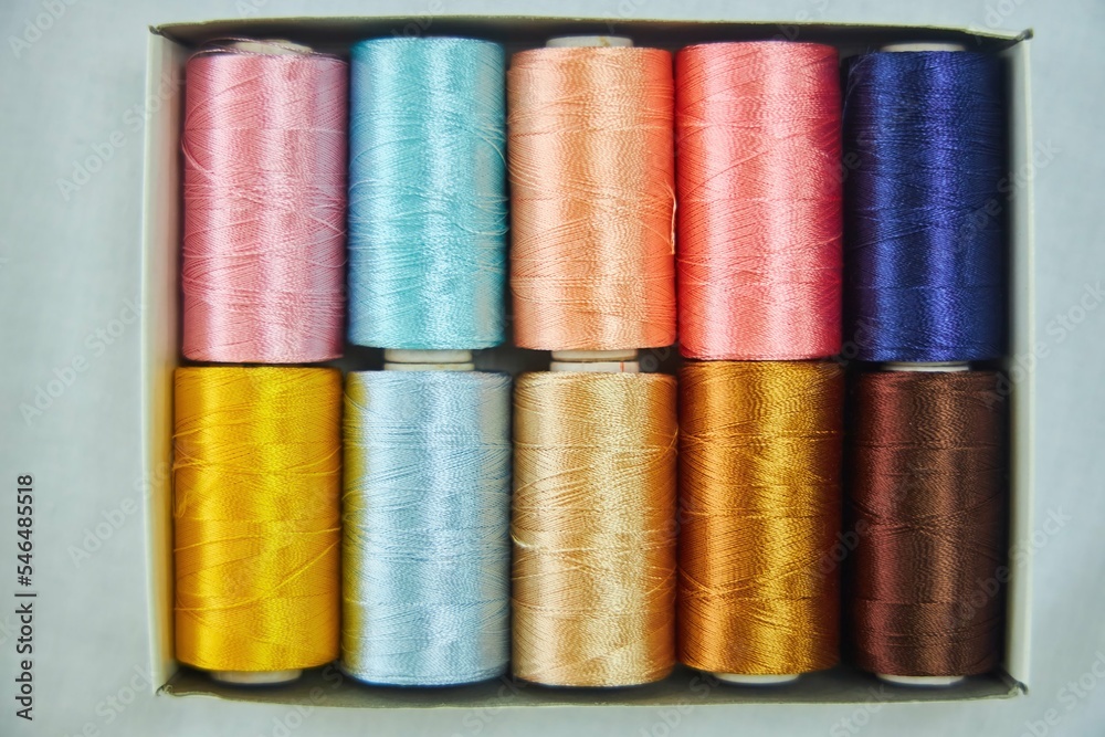 Close - up of coils of threads of different colors and shades for sewing, embroidery and creativity. The concept of Hobbies and crafts. Close - up of coils of threads of different colors and shades for sewing, embroidery and creativity. The concept of Hobbies and crafts.