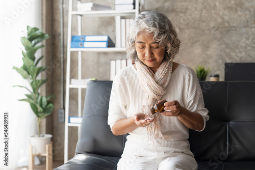 Mature woman taking out pills from bottle, supplements or antibiotic, older female preparing to take emergency medicine, chronic disease, healthcare and treatment concept