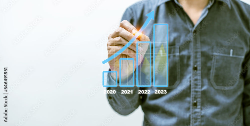 Businessman draw growth graph and progress of business and analyzing financial and investment data ,business planning, business strategy, set goals and achievement in 2023