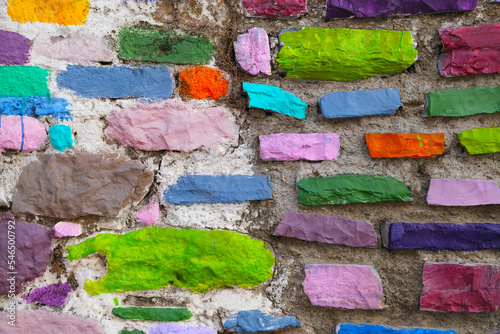 Colorful painted rough stone wall