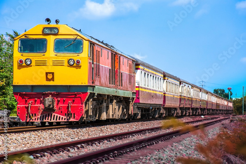 Passenger train by diesel locomotive on the railway.