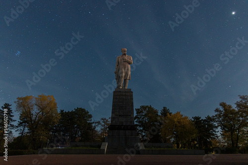 Monument to Taras Shevchenko, Ukrainian poet, writer, artist, public and political figure, as well as folklorist and ethnographer Taras Shevchenko in the city of Dnipro, Ukraine. Night photo, stars. photo