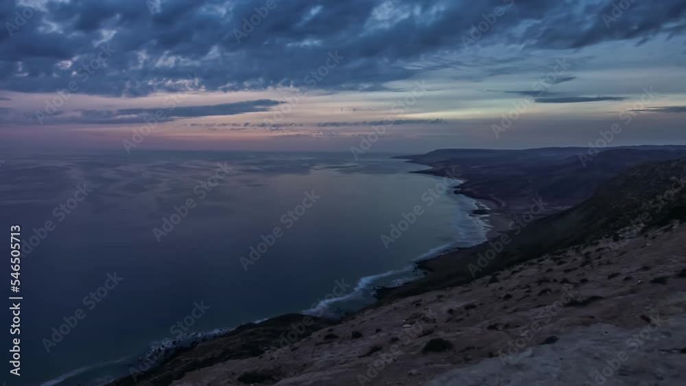 Calm sea at sunset along Agadir coastline and cloudscape, Morocco. Day-to-night timelapse Calm sea at sunset along Agadir coastline and cloudscape, Morocco. Day-to-night timelapse