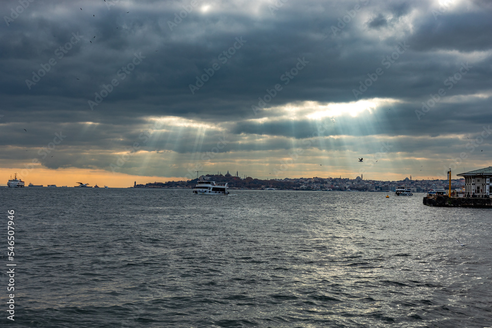 View of the old city of Istanbul across the Bosphorus. Dramatic sky.