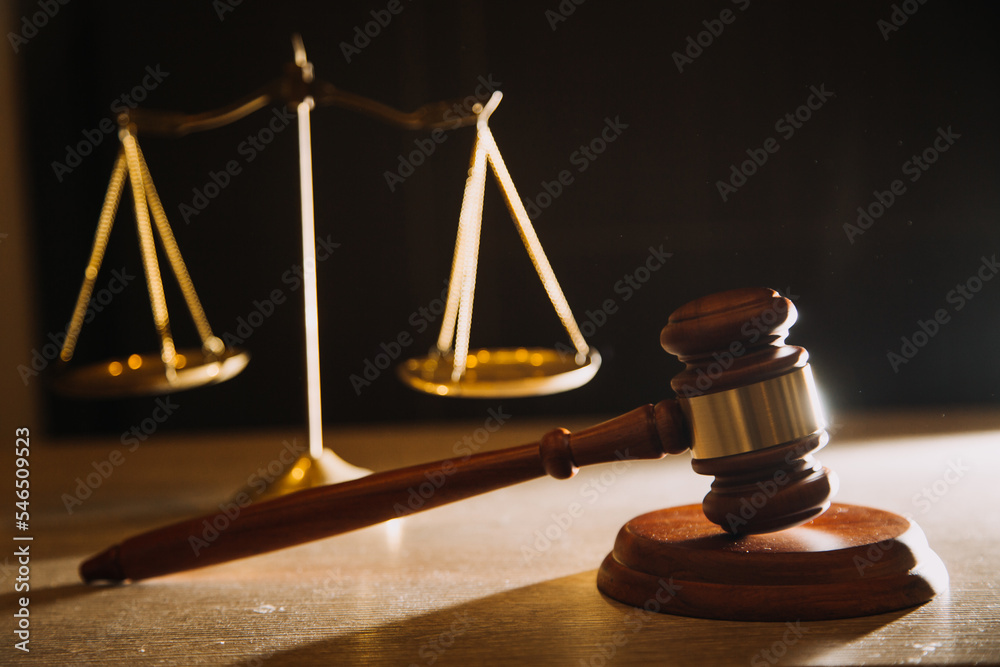 Business and lawyers discussing contract papers with brass scale on desk in office. Law, legal services, advice, justice and law concept Business and lawyers discussing contract papers with brass scale on desk in office. Law, legal services, advice, justice and law concept