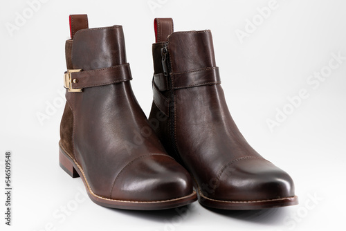 Elegant, brown women's winter boots on a white background. Soft artificial light showing the texture of the material