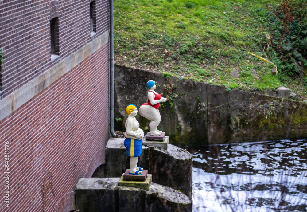 small dams and mills. Two floating human statues by the lake. Parks and