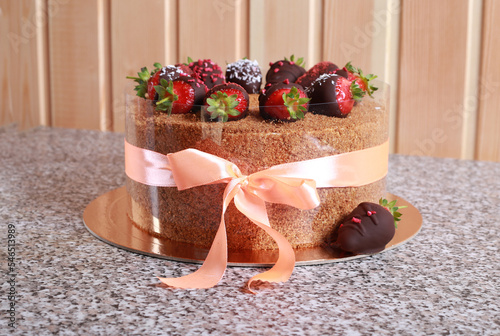 Close-up birthday cake with chocolate covered strawberries