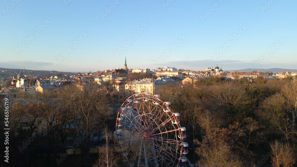 aerial view of the abandoned amusement park that is closed because of war. observation wheel,  landscape, architecture, small town,trees. fun fair. solitary, empty park top view