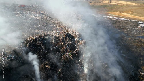 Aerial view of burning trash piles in landfill