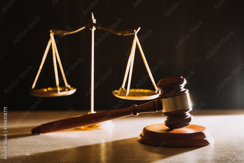 law books and scales of justice on desk in library of law firm. jurisprudence legal education concept. law books and scales of justice on desk in library of law firm. jurisprudence legal education concept.