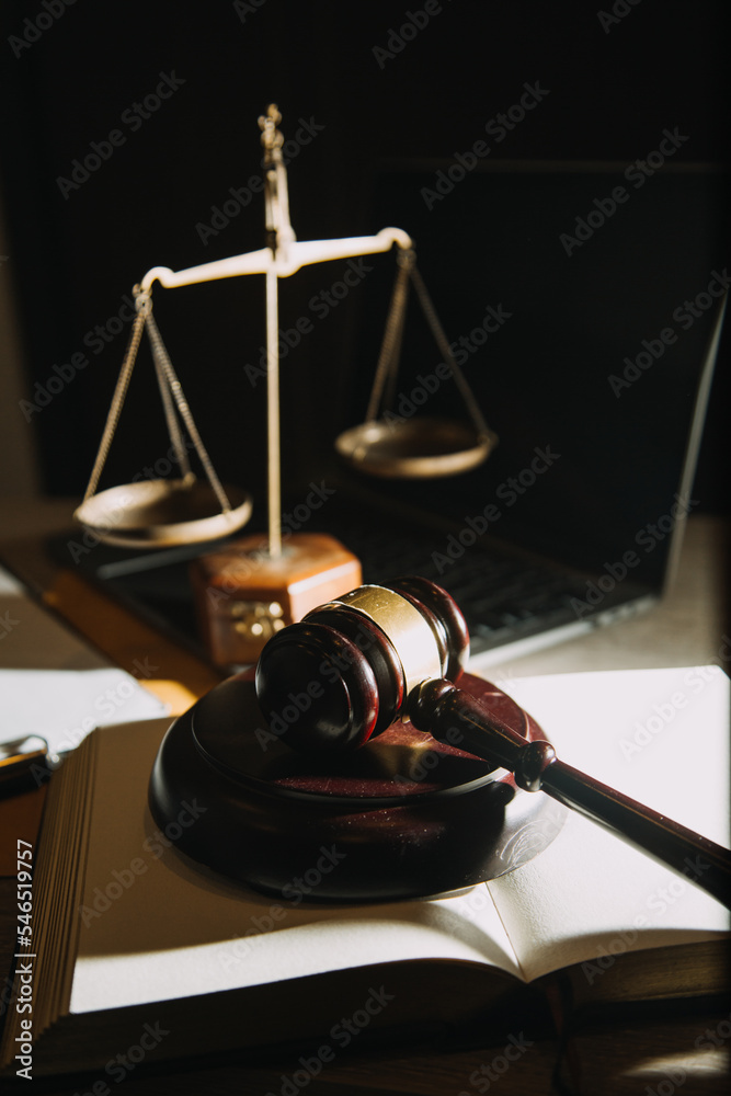 law books and scales of justice on desk in library of law firm. jurisprudence legal education concept. law books and scales of justice on desk in library of law firm. jurisprudence legal education concept.
