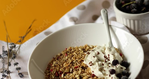Rotation of morning granola breakfast with greek yougurt and blueberry, Homemade oatmeal granola, healthy food.