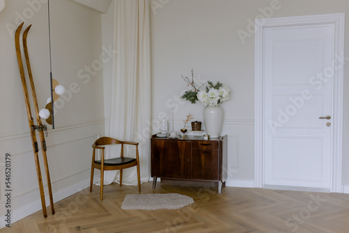 Stylish interior in a vintage house with beige walls. Designer white door. French decor.