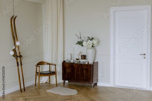Stylish interior in a vintage house with beige walls. Designer white door. French decor.