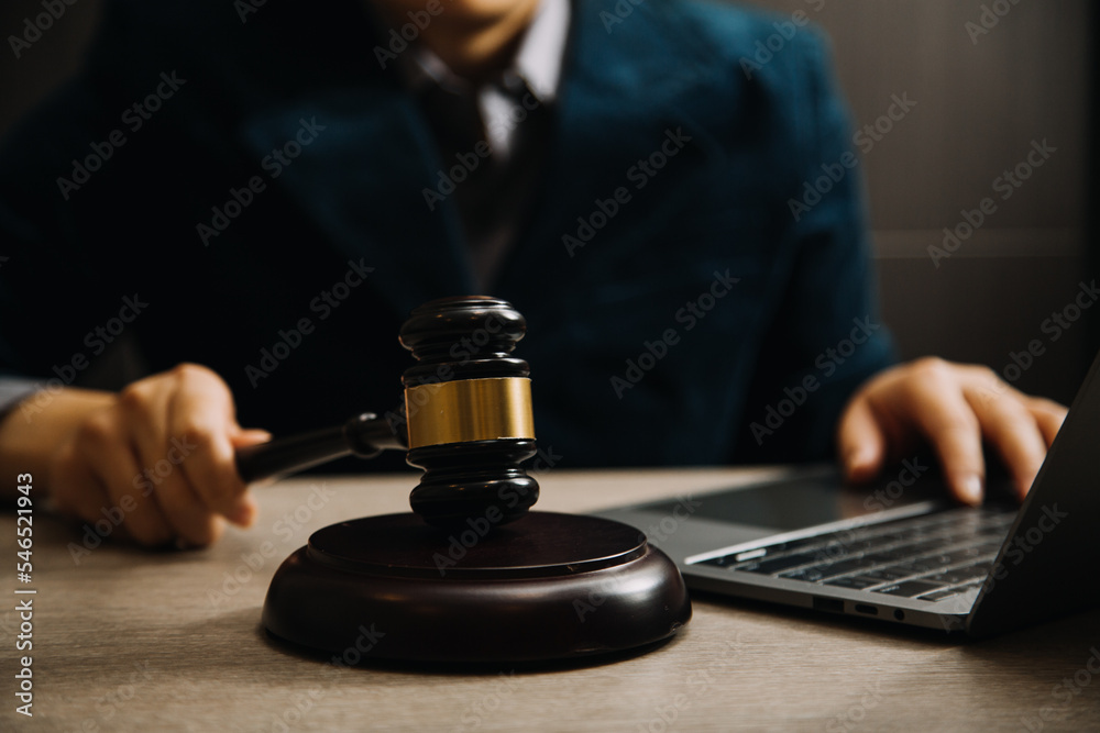 Business and lawyers discussing contract papers with brass scale on desk in office. Law, legal services, advice, justice and law concept picture with film grain effect Business and lawyers discussing contract papers with brass scale on desk in office. Law, legal services, advice, justice and law concept picture with film grain effect