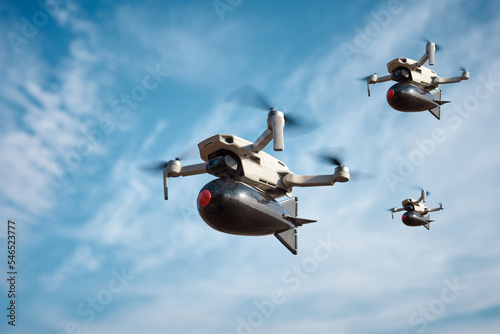 three consumer civilian drones with a big bomb on board flies in the blue sky