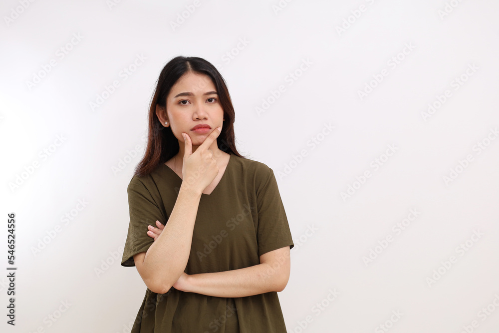 Angry and unfriendly expression of young asian woman standing while looking at the camera. Isolated on white background Angry and unfriendly expression of young asian woman standing while looking at the camera. Isolated on white background