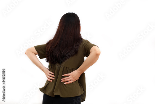 Back view of young asian woman standing while suffering from low back pain. Isolated on white with copyspace