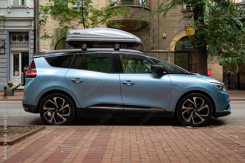Light blue minivan Renault Grand Scenic 4th generation (2016) with Thule  roof rack box on it's top, Side view. Subotica, Serbia, 25.08.2022.  Stock-Foto | Adobe Stock