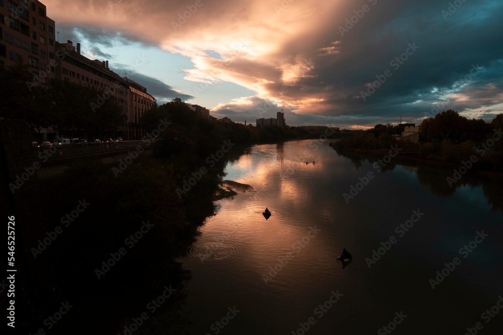 Autumn photography at sunset from the Basilica of Our Lady of the Pilar in Zaragoza, next to the Ebro river and the Stone Bridge, Aragon, Spain.
