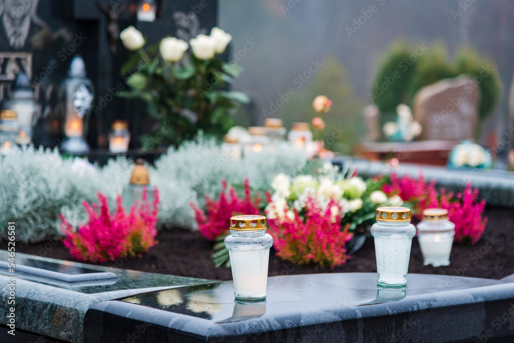 All Saints' Day and burning candles and flowers on the graves.Candles