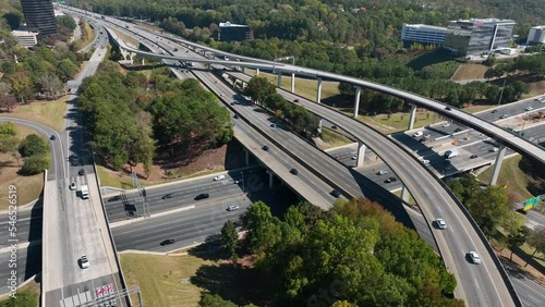 Cars drive fast on freeway. Interstate highway road. Transportation and commuting theme. Aerial view. photo