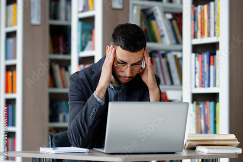Man using laptop and feeling stressed