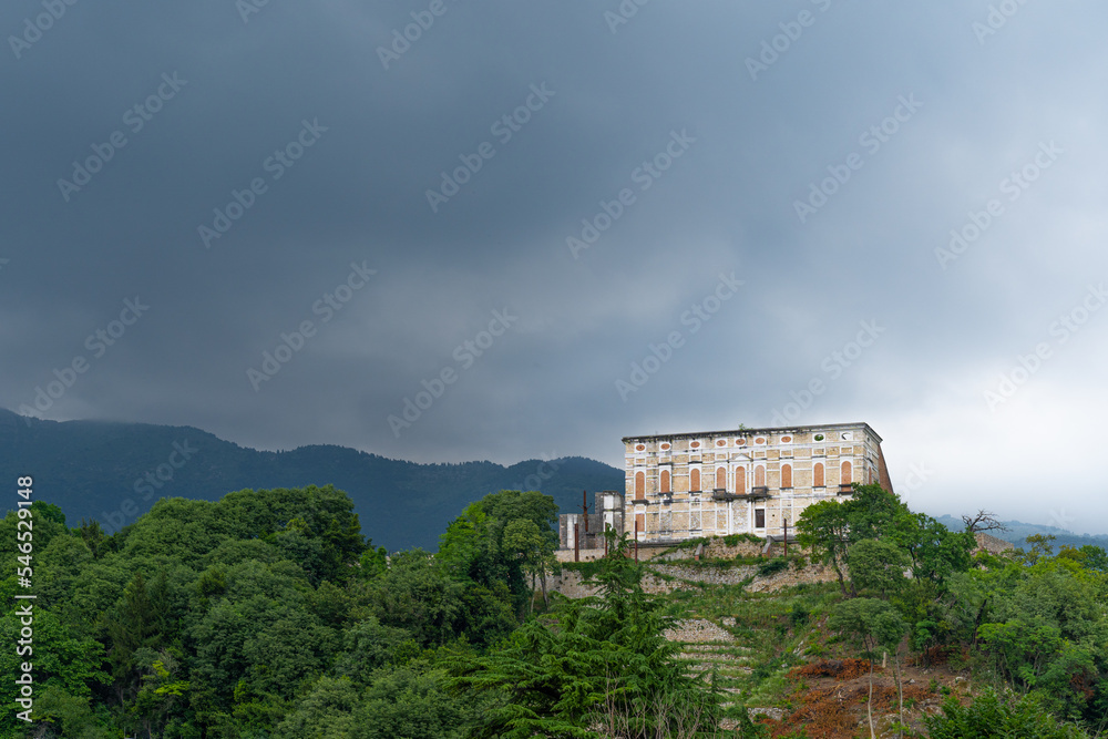 An abandoned castle on top of a forest hill in Aviano, Italy