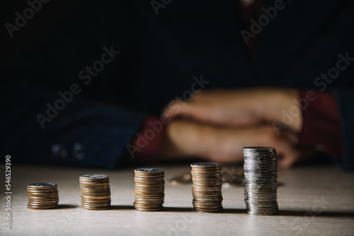 Hand putting coin money on pile coin. Invest concept. photo