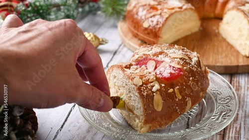 Man's hand removing the king from the Epiphany cake or Roscón de Reyes photo