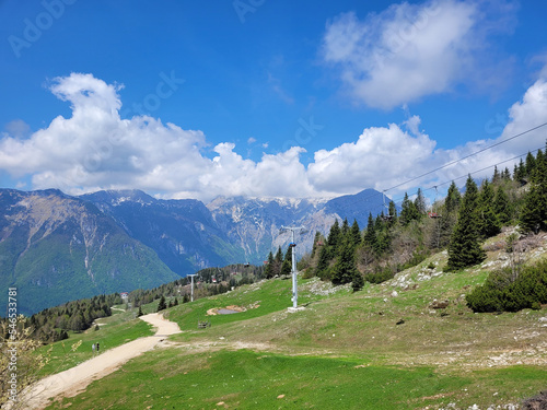 Big Pasture Plateau in the Kamnik Alps, Slovenia. Mountains cottage hut or house on green hill. Alpine meadow landscape. 