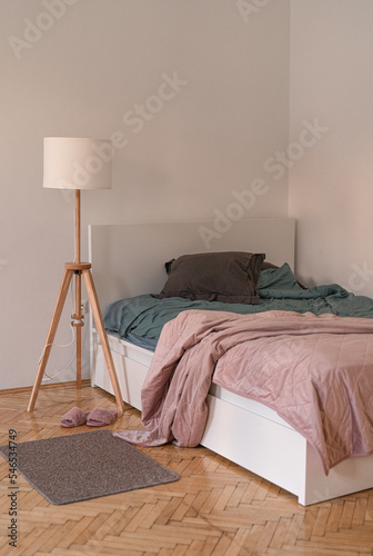 cozy white bed with a pink cover