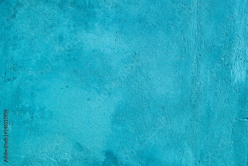 Photo of a turquoise concrete wall aged by time and weather