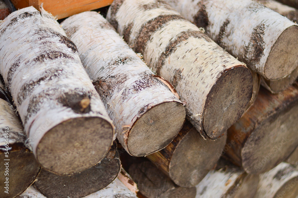 Stack of dried firewood from birch wood. Harvesting wood for the winter. Firewood background. Selective focus Stack of dried firewood from birch wood. Harvesting wood for the winter. Firewood background. Selective focus