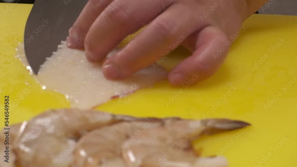 The chef cuts the fish into slices on a board The chef cuts the fish into slices on a board