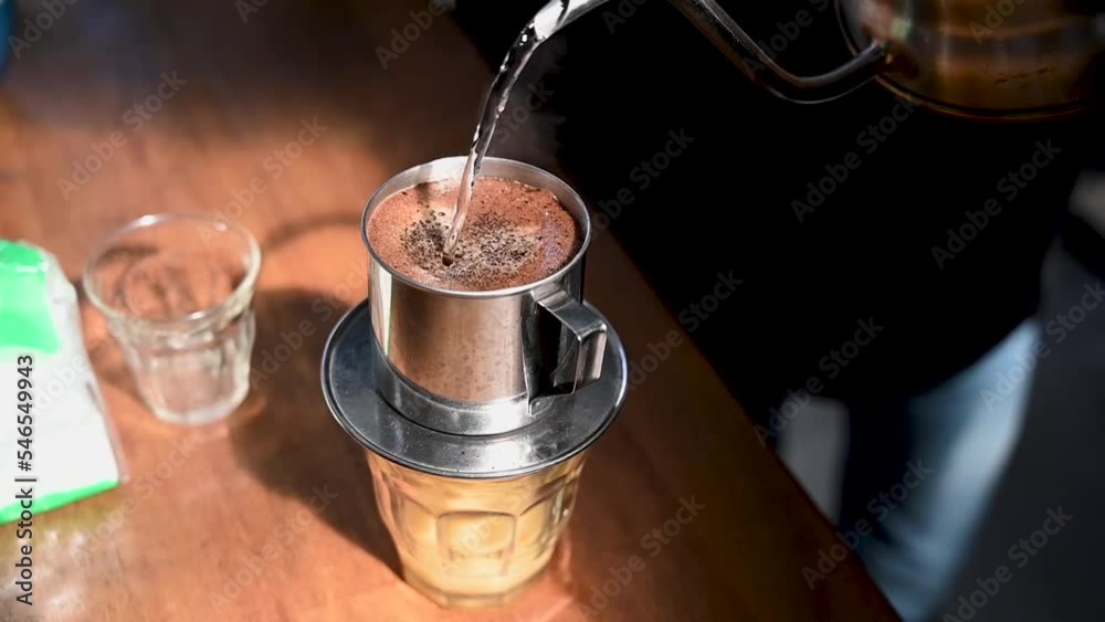 the process of serving Vietnamese drip coffee, from filtering drips to the coffee cup