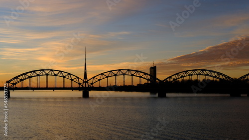 Television tower against the background of the railway bridge at dawn in Riga