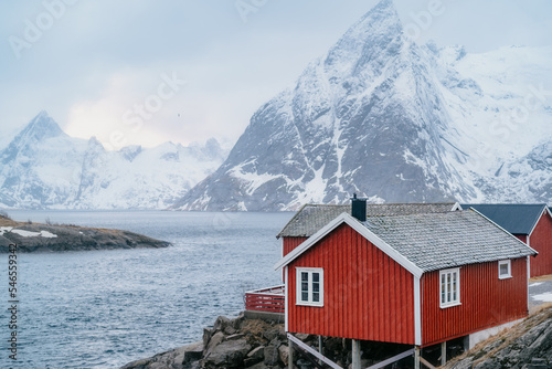Landscape photograph of red cabin in the mountains of Norway. Fjords of Lofoten