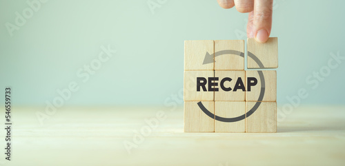Recap economy, business, financial concept. For business planning. RECAP word icon on wooden cubes on smart grey background and copy space..