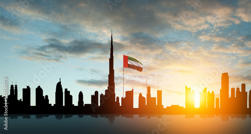 Canvas Print United Arab Emirates flag and Dubai skyline view at sunset
