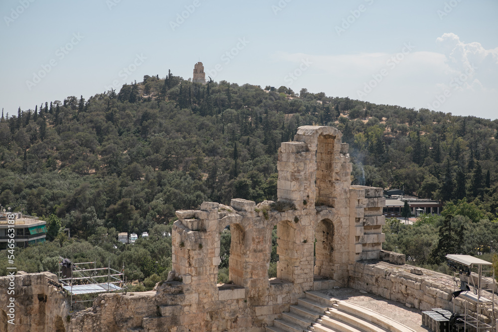 Ancient Greek ruins in Athens, Greece, Europe. Odeon of Herodes Atticus overlooking city. This stone theater is famous landmark of Athens. Old monument close-up, remains of classical Athens.