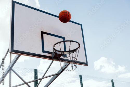 Scoring winning points at basketball game ball flies through basket outside game. © ABCreative